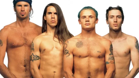member of the red hot chili peppers pose without a shirt